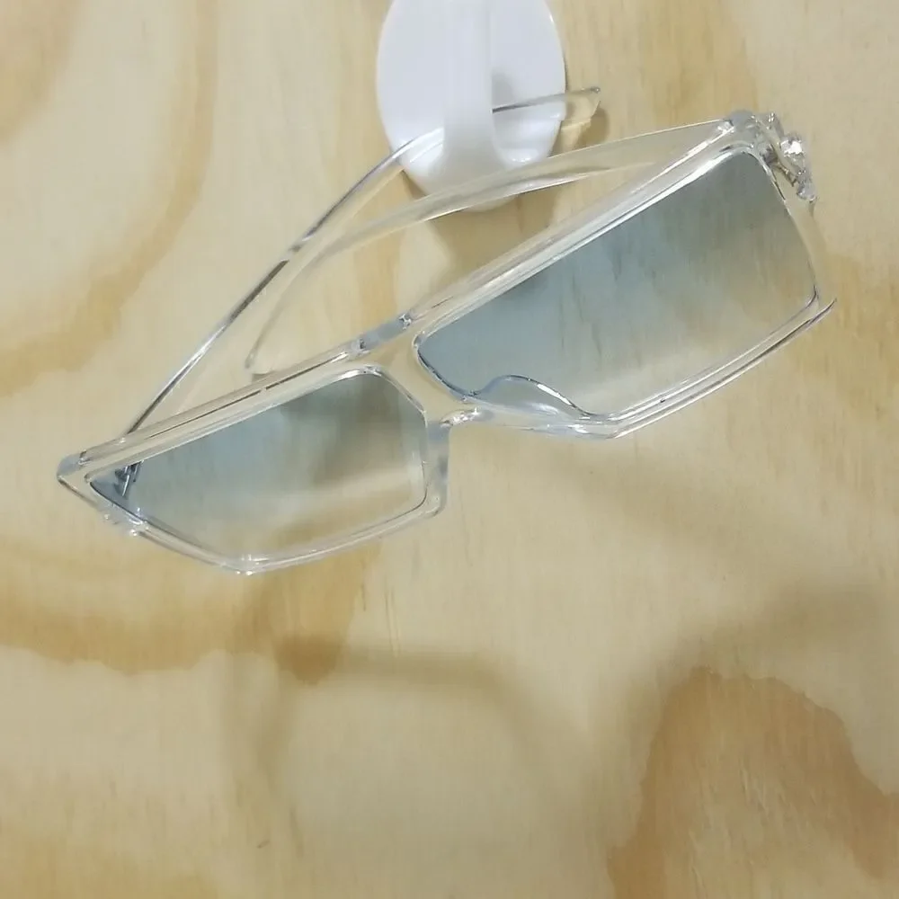 High Fashion Women's Sunglasses with clear frames/ blue tented lenses.